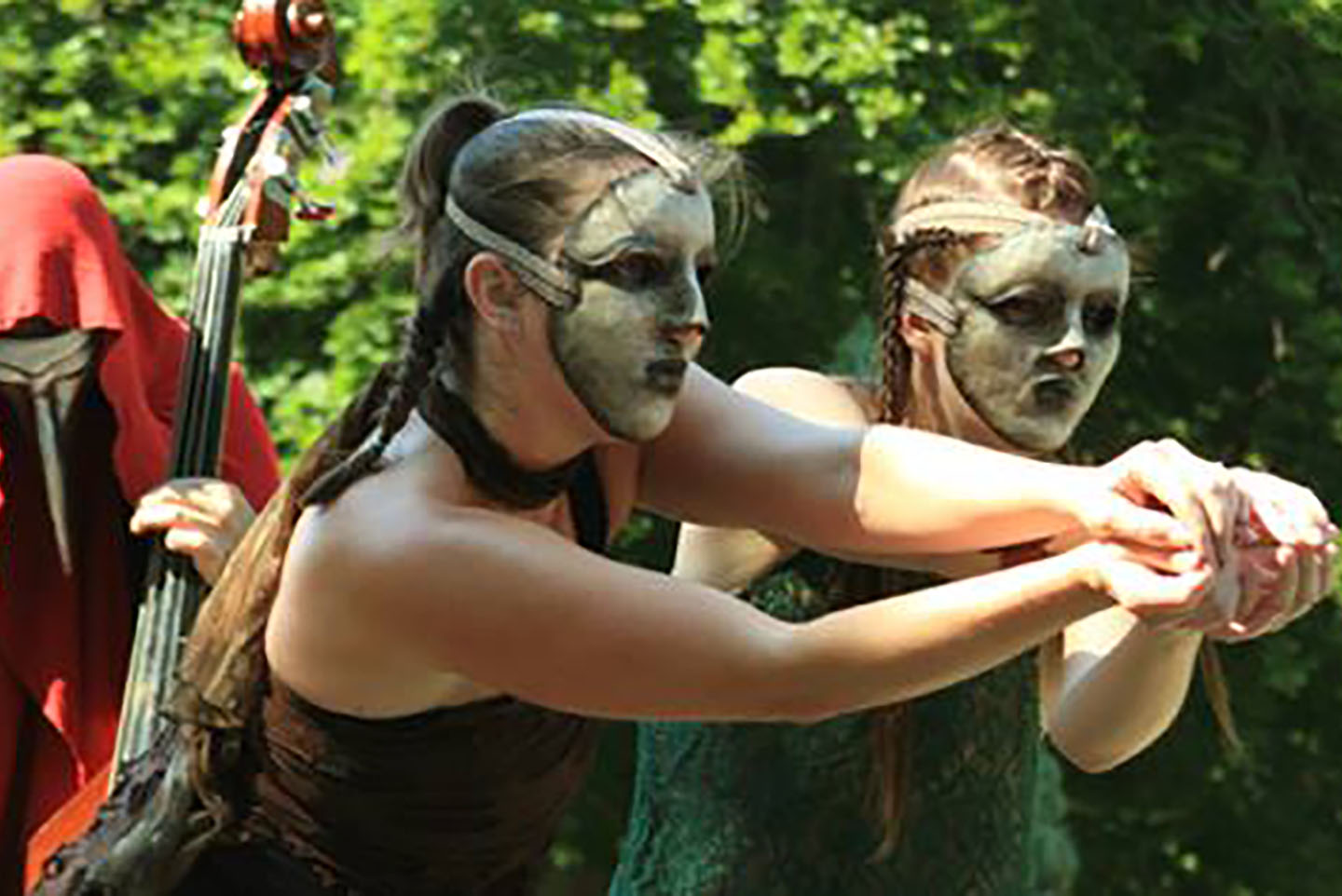 Image of 2 MorrisonDancers dancing with masks in a garden